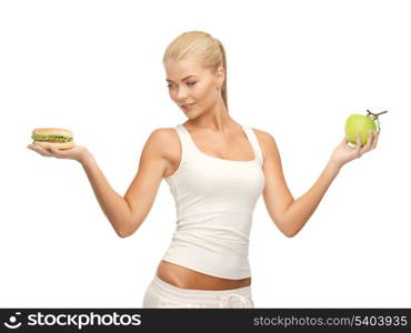 picture of sporty woman with apple and hamburger