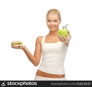 picture of sporty woman with apple and hamburger