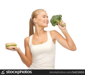 picture of sporty woman with broccoli and hamburger