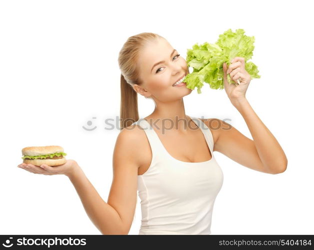 picture of sporty woman with green lettuce and hamburger