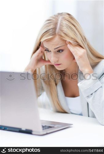 picture of stressed businesswoman with laptop at work