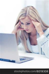 picture of stressed businesswoman with laptop at work. stressed woman with laptop