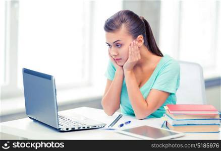 picture of stressed student with computer at home. stressed student with computer at home