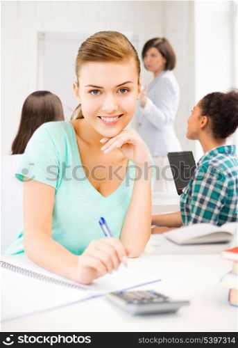 picture of student girl with notebook and calculator at school