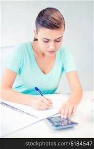 picture of student girl with notebook and calculator. student girl with notebook and calculator
