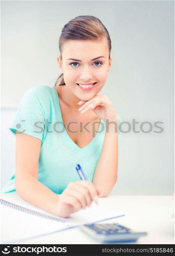 picture of student girl with notebook and calculator. student girl with notebook and calculator