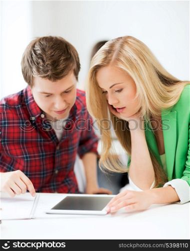 picture of students looking at tablet pc at school