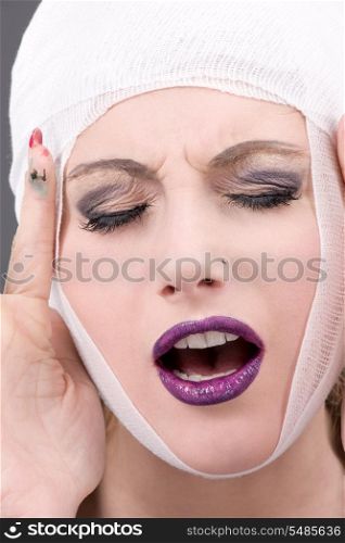 picture of suffering woman face over grey
