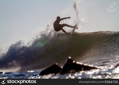 Picture of Surfing a Wave at Sunrise Time