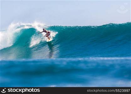 picture of surfing a wave in Indonesia.