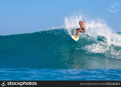 picture of surfing a wave in Indonesia.