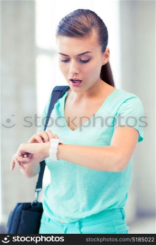 picture of surprised student girl looking at clock. surprised student girl looking at clock