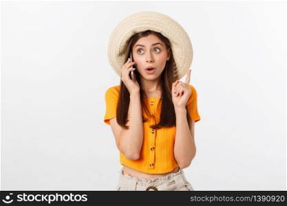 Picture of surprised voyage girl looking shock while holding phone in hands isolated over grey background.. Picture of surprised voyage girl looking shock while holding phone in hands isolated over grey background