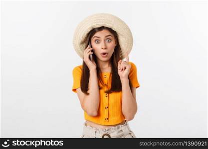 Picture of surprised voyage girl looking shock while holding phone in hands isolated over grey background.. Picture of surprised voyage girl looking shock while holding phone in hands isolated over grey background
