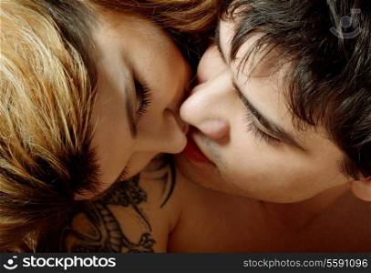 picture of sweet couple kissing in bed