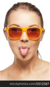 picture of teenage girl in shades sticking out her tongue