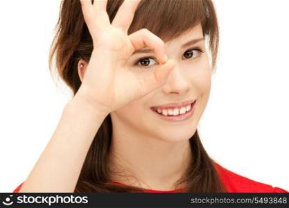 picture of teenage girl looking through hole from fingers