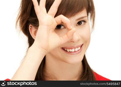 picture of teenage girl looking through hole from fingers