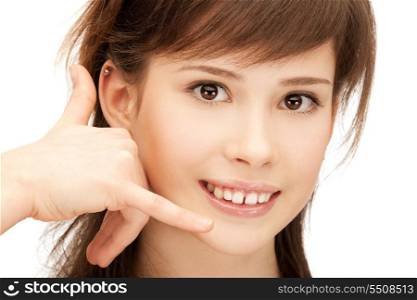 picture of teenage girl making a call me gesture