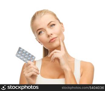 picture of thoughtful young woman with pills