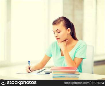 picture of tired student writing in notebook
