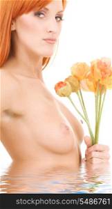 picture of topless redhead with flowers in water