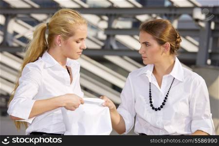 picture of two angry businesswomen fighting for contract
