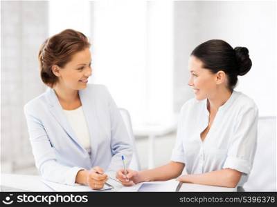 picture of two businesswomen having discussion in office