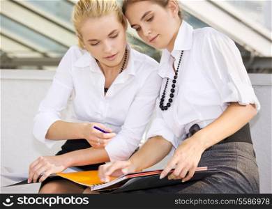 picture of two businesswomen working with documents