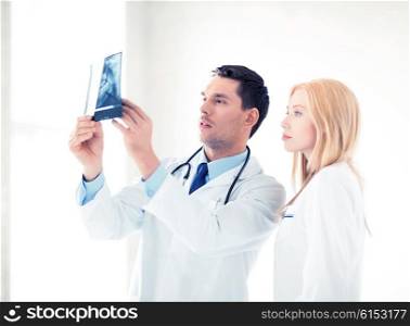 picture of two doctors looking at x-ray. two doctors looking at x-ray