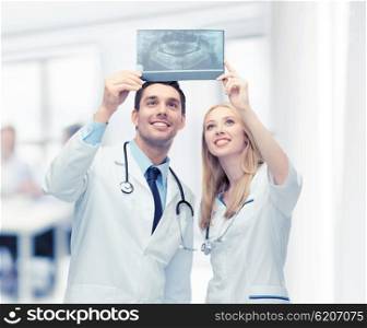 picture of two doctors looking at x-ray. two doctors looking at x-ray
