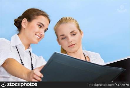 picture of two happy businesswomen (focus on brunette)
