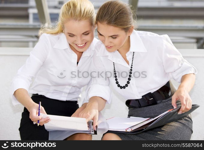 picture of two happy businesswomen with documents