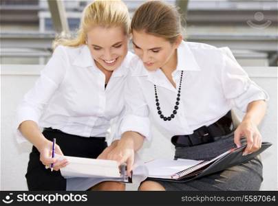 picture of two happy businesswomen with documents