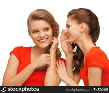 picture of two talking teenage girls in red t-shirts