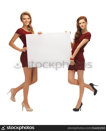 picture of two teenage girls in red dresses with blank board