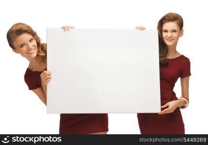 picture of two teenage girls in red dresses with blank board