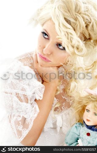 picture of unhappy bride holding doll over white
