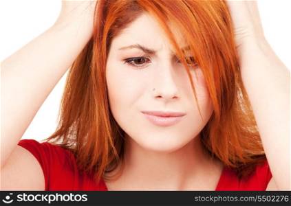 picture of unhappy redhead woman over white
