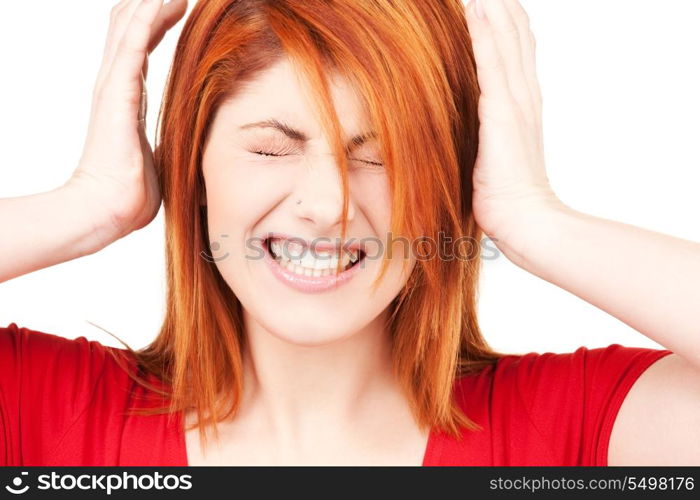 picture of unhappy redhead woman with hands on ears