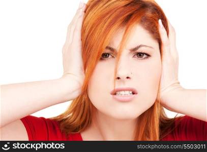 picture of unhappy redhead woman with hands on ears
