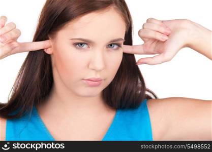 picture of unhappy teenage girl with fingers in ears