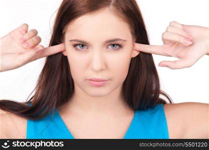 picture of unhappy teenage girl with fingers in ears