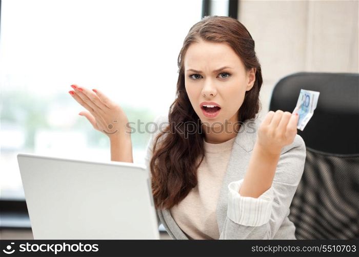 picture of unhappy woman with laptop computer and euro cash money