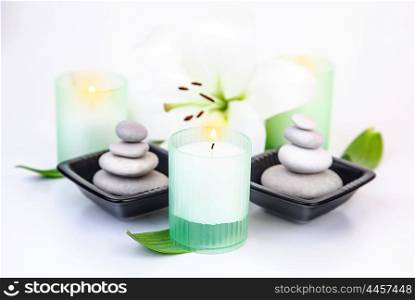 Picture of white lily flower, candles, pebble stones isolated on white background, beauty salon, luxury spa resort, alternative treatment, zen balance, aroma therapy, wellness and wellbeing concept
