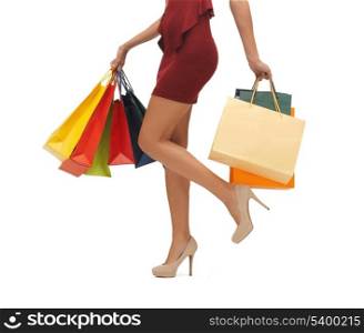 picture of woman&#39;s long legs with shopping bags.