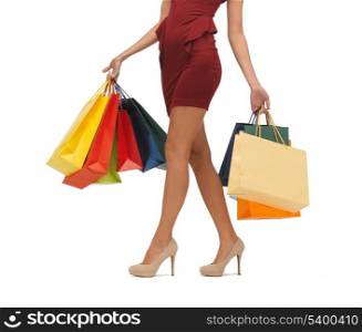 picture of woman&#39;s long legs with shopping bags.
