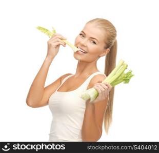 picture of woman biting piece of celery or green salad