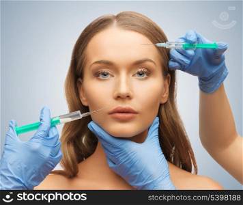 picture of woman face and beautician hands with syringes