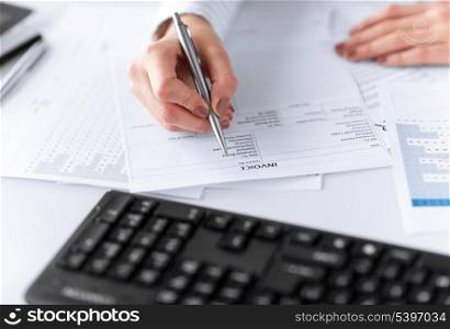 picture of woman hand filling in invoice paper